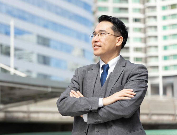 Business man standing in front of buildings